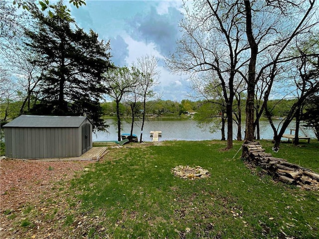 58 E Sugar Lake Cv, Mound City, KS 66056 - view of yard with an outdoor structure, a storage shed, and a water view