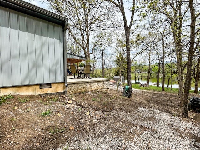 58 E Sugar Lake Cv, Mound City, KS 66056 - view of yard featuring a water view and a patio