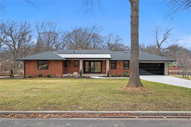 view of front of house featuring brick siding, a front lawn, concrete driveway, and an attached garage