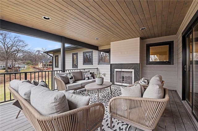 deck featuring an outdoor living space with a fireplace