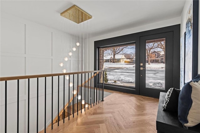 interior space featuring an upstairs landing and a decorative wall