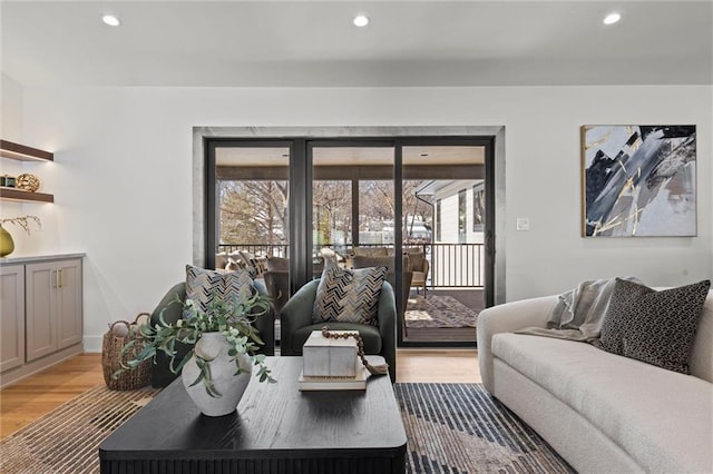 living area featuring recessed lighting, light wood-style flooring, and plenty of natural light
