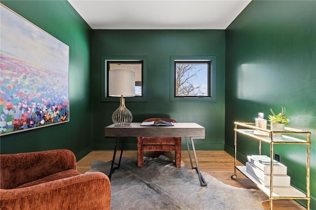 home office featuring wood finished floors and baseboards