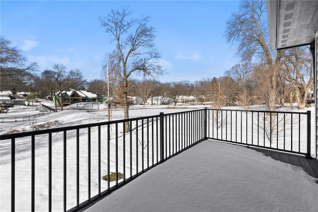 view of snow covered back of property