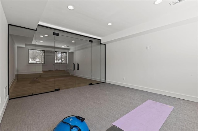 exercise room with recessed lighting, carpet flooring, and visible vents