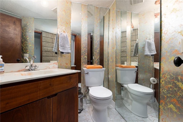 bathroom featuring toilet, visible vents, wallpapered walls, and vanity