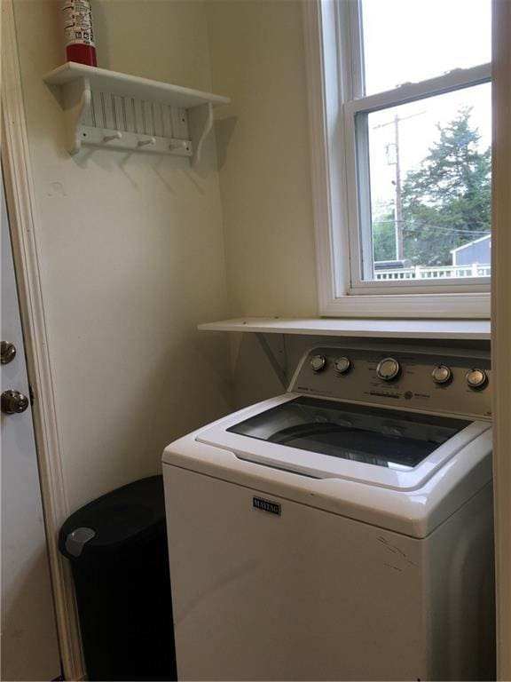 clothes washing area with laundry area and washer / dryer