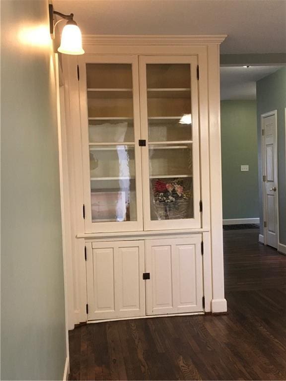 interior details featuring baseboards and wood finished floors