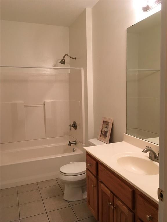 bathroom featuring toilet, tile patterned floors, bathtub / shower combination, and vanity
