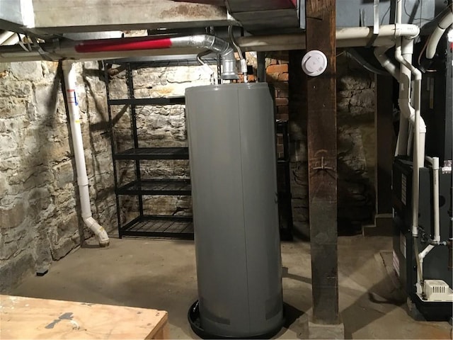utility room featuring heating unit and gas water heater