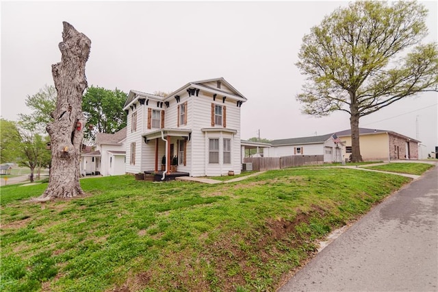 view of front of home featuring a front lawn, fence, and cooling unit