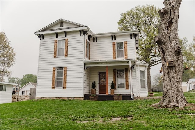 view of front of house with a porch and a front lawn