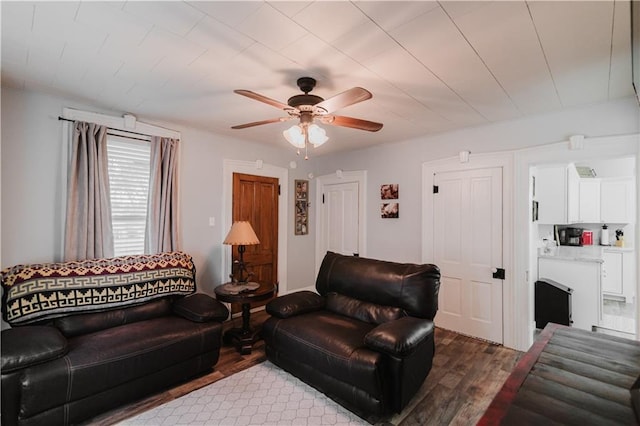 living room with a ceiling fan and wood finished floors