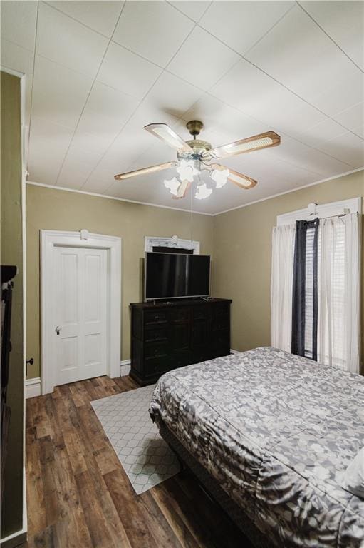 bedroom with a ceiling fan and wood finished floors