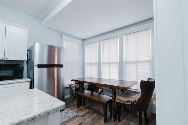 dining space with wood finished floors