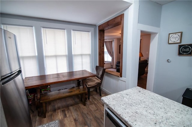 dining space featuring dark wood-style floors