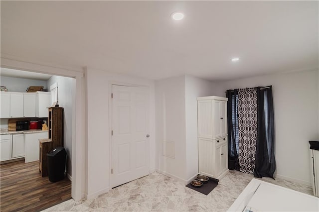 interior space featuring baseboards and recessed lighting