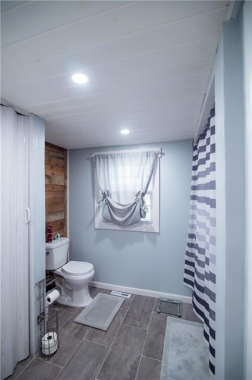 bathroom featuring visible vents, toilet, wooden walls, recessed lighting, and a shower with shower curtain