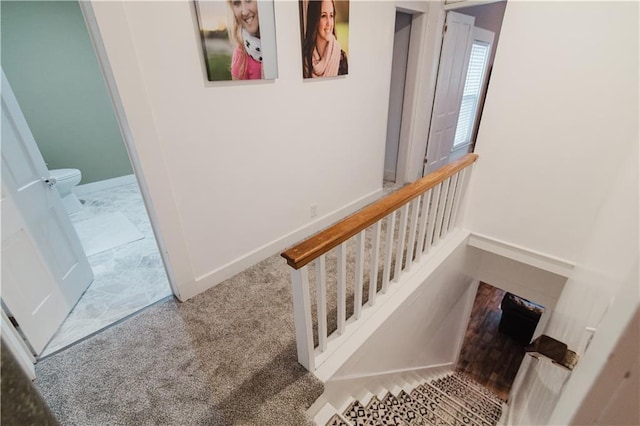 staircase with carpet floors and baseboards