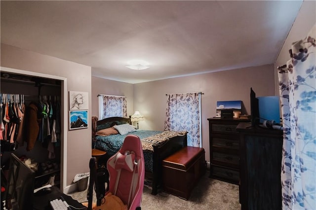 bedroom with carpet and a closet
