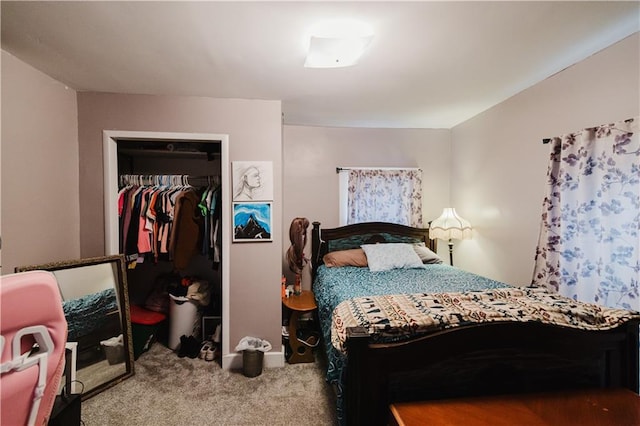 bedroom featuring a walk in closet, a closet, and carpet flooring