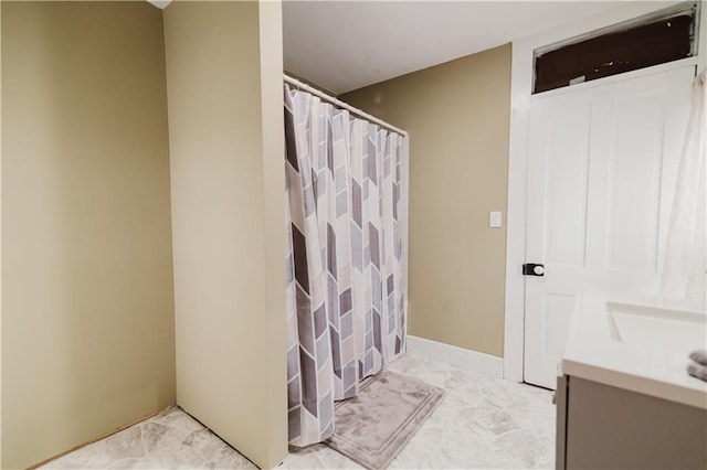 bathroom featuring vanity, marble finish floor, and a shower with curtain