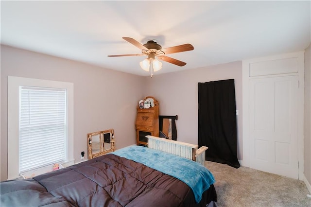 carpeted bedroom with a ceiling fan