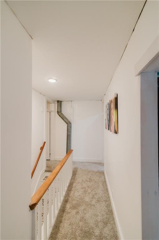 hall with carpet flooring and baseboards