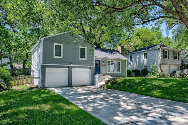 7636 Windsor St, Prairie Village, KS 66208 - split level home with an attached garage, concrete driveway, and a chimney