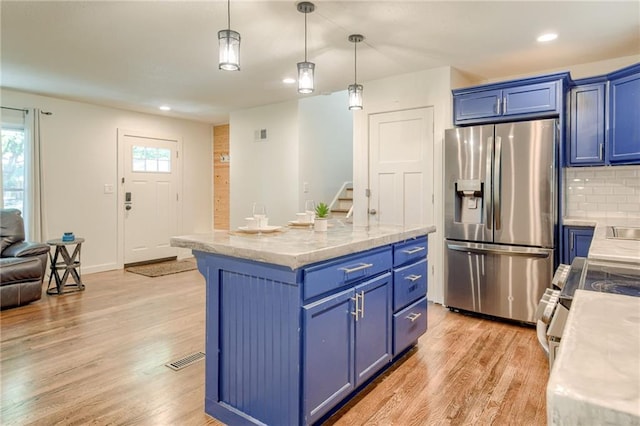 7636 Windsor St, Prairie Village, KS 66208 - kitchen featuring appliances with stainless steel finishes, blue cabinets, light wood finished floors, and recessed lighting