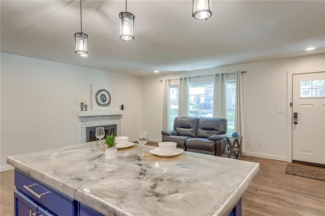 7636 Windsor St, Prairie Village, KS 66208 - dining space featuring baseboards, light wood-type flooring, a fireplace, and recessed lighting