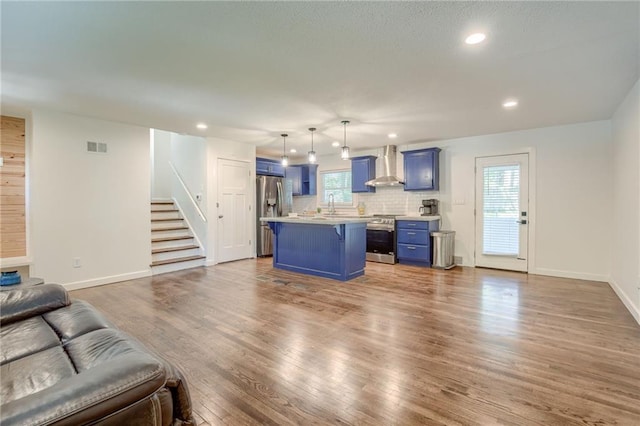 7636 Windsor St, Prairie Village, KS 66208 - living area featuring wood finished floors, stairway, recessed lighting, and baseboards