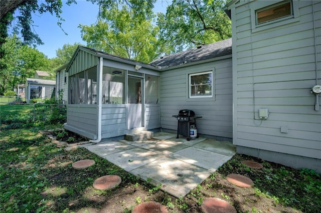 7636 Windsor St, Prairie Village, KS 66208 - back of property featuring a sunroom, a patio area, and a shingled roof