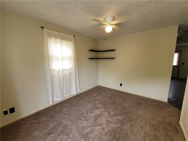 601 S 24th St, Lexington, MO 64067 - unfurnished room featuring a ceiling fan, dark carpet, a textured ceiling, and baseboards