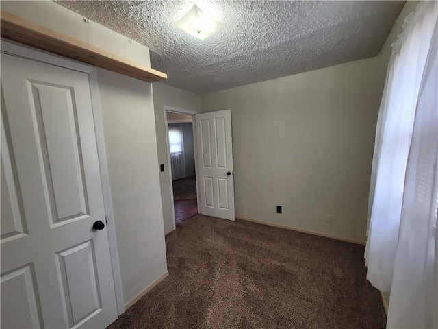 601 S 24th St, Lexington, MO 64067 - carpeted spare room with a textured ceiling and baseboards