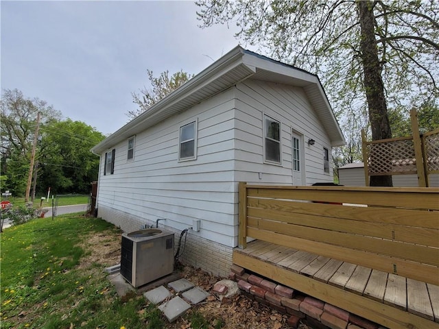 601 S 24th St, Lexington, MO 64067 - view of side of property featuring a deck, cooling unit, and a yard