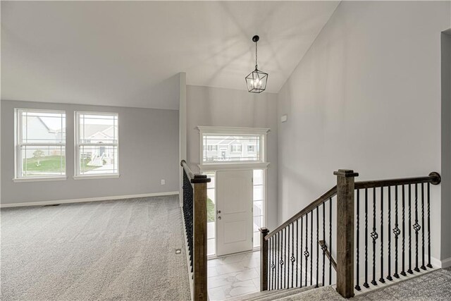 11802 N Bellaire Ave, Kansas City, MO 64156 - carpeted foyer with a chandelier, baseboards, and vaulted ceiling