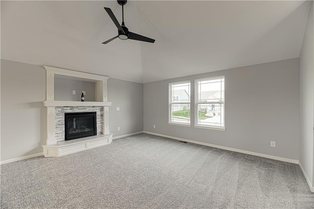 11802 N Bellaire Ave, Kansas City, MO 64156 - unfurnished living room with a ceiling fan, carpet, vaulted ceiling, a stone fireplace, and baseboards