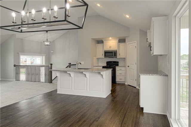 11802 N Bellaire Ave, Kansas City, MO 64156 - kitchen featuring black range with electric stovetop, stainless steel microwave, tasteful backsplash, light stone countertops, and dark wood-style flooring
