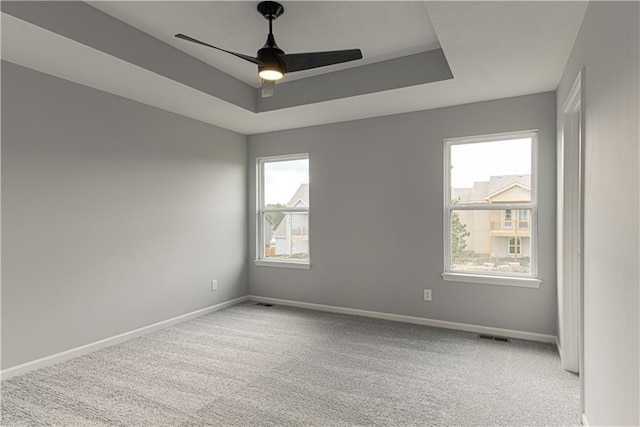 11802 N Bellaire Ave, Kansas City, MO 64156 - unfurnished room with ceiling fan, baseboards, carpet flooring, and a raised ceiling