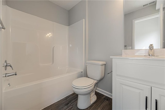11802 N Bellaire Ave, Kansas City, MO 64156 - full bathroom with toilet, wood finished floors, baseboards, vanity, and shower / washtub combination