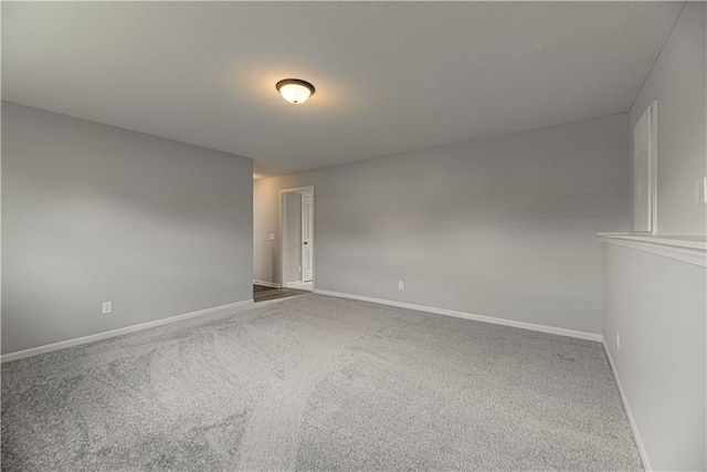 11802 N Bellaire Ave, Kansas City, MO 64156 - spare room featuring carpet flooring and baseboards