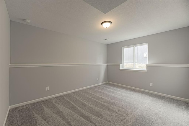 11802 N Bellaire Ave, Kansas City, MO 64156 - empty room featuring a smoke detector, carpet flooring, a textured ceiling, and baseboards