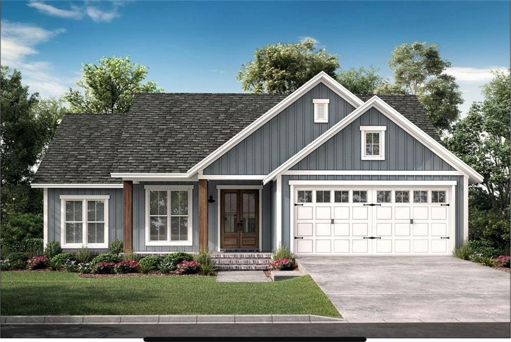 view of front of property featuring a front lawn, driveway, french doors, an attached garage, and roof with shingles