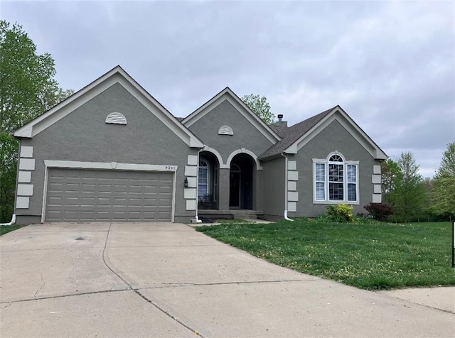 9201 N Harrison St, Kansas City, MO 64155 - ranch-style home featuring driveway, a garage, a front yard, and stucco siding