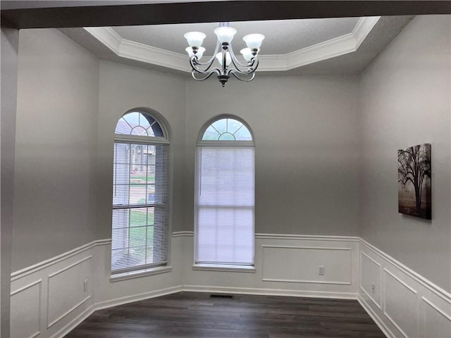 9201 N Harrison St, Kansas City, MO 64155 - unfurnished room with a raised ceiling, ornamental molding, dark wood-style floors, a chandelier, and a decorative wall