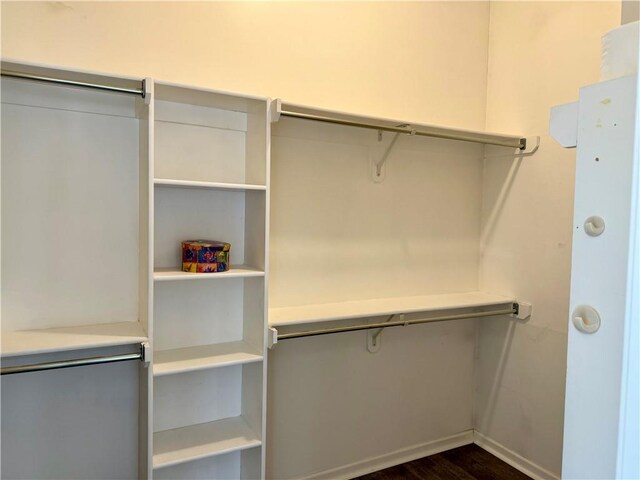 9201 N Harrison St, Kansas City, MO 64155 - spacious closet featuring dark wood-type flooring