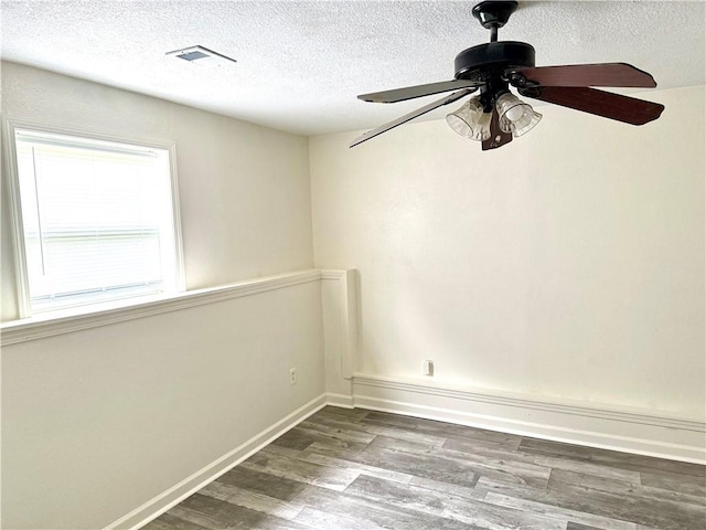 9201 N Harrison St, Kansas City, MO 64155 - empty room featuring wood finished floors, a textured ceiling, ceiling fan, and baseboards