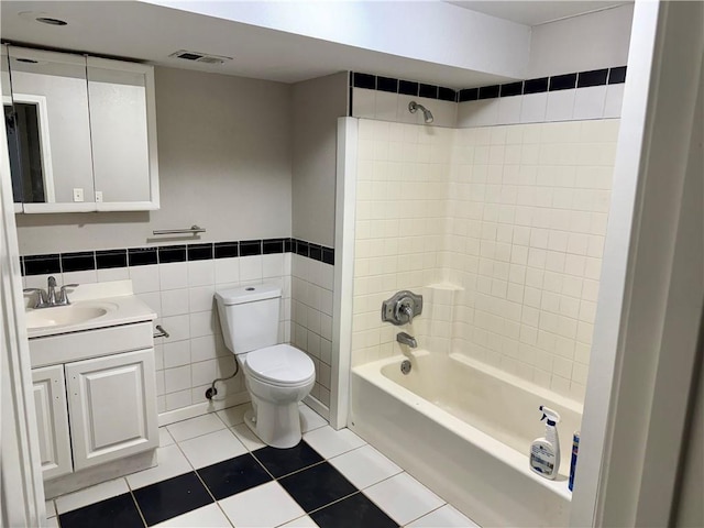 9201 N Harrison St, Kansas City, MO 64155 - bathroom featuring tile patterned floors, toilet, washtub / shower combination, tile walls, and vanity