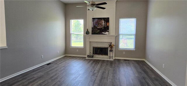 9201 N Harrison St, Kansas City, MO 64155 - unfurnished living room with dark wood-style flooring, a ceiling fan, a fireplace, and baseboards